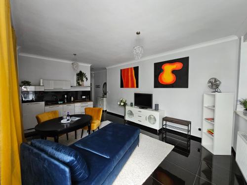 a living room with a blue couch and a table at Bismarck-Apartment in Kaiserslautern