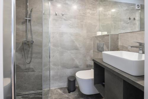 a bathroom with a shower and a toilet and a sink at Residence INN Rijeka in Rijeka