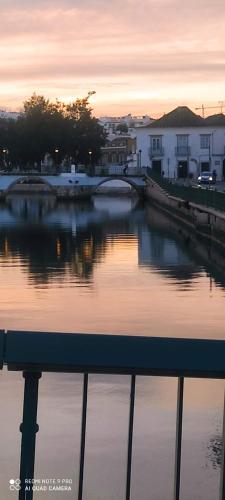 a river with a bridge in a city at sunset at Casa D'Nossa, casa tradicional e Moderna, vista 360º, piscina de agua salgada in Luz de Tavira