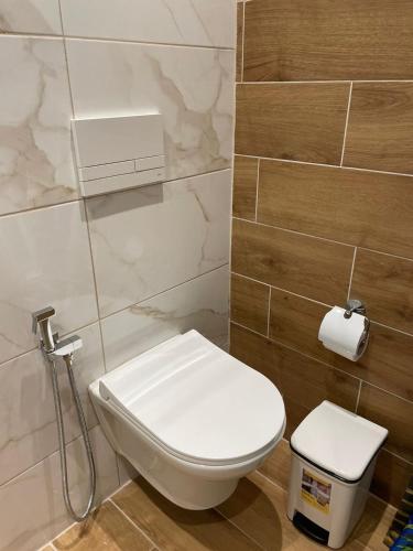 a bathroom with a white toilet and a sink at Hotel ABA in Ksamil