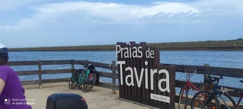 a group of bikes parked next to a fence near the water at Casa D'Nossa, casa tradicional e Moderna, vista 360º, piscina de agua salgada in Luz de Tavira