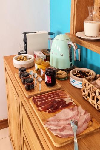 a counter with a cutting board with meat and a mixer at Blue Ocean Suites & Apartments in Trou dʼ Eau Douce