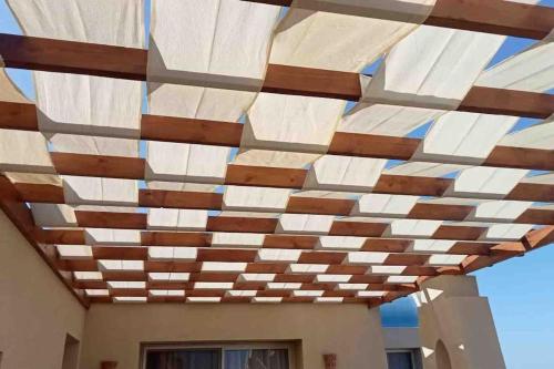 awning over a building with a building at Azzurra two-bedrooms apartment at Sahl Hasheesh in Hurghada