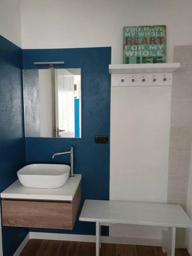 a bathroom with a sink and a mirror at Jazz House in Solanas