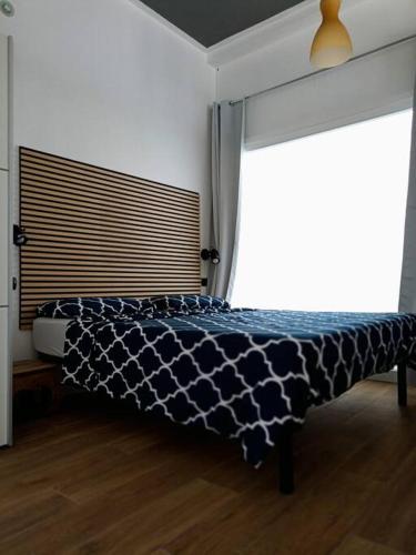 a bedroom with a bed and a large window at Jazz House in Solanas