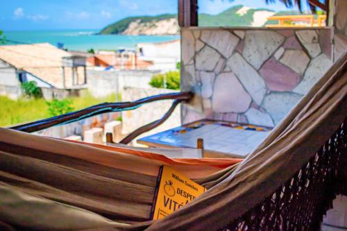 a hammock in a room with a view of the ocean at Castelo Beach Hotel in Natal