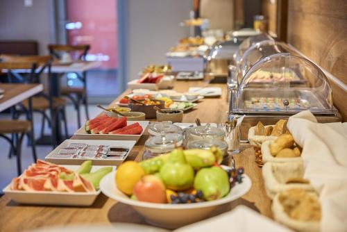 a buffet line with plates of food on a table at HOTEL Garni PATRIOT in Trnava