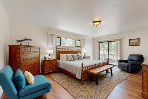 a bedroom with a bed and a couch and a chair at Walling Mountain Retreat in Groveland