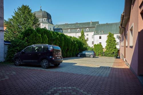 a car parked in a parking lot in front of a building at HOTEL Garni PATRIOT in Trnava