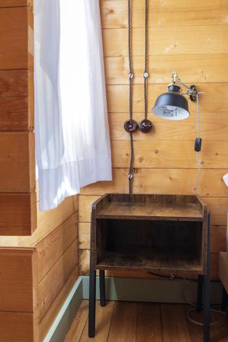 a wooden room with a table and a lamp at Finca Florida in Benalup Casas Viejas