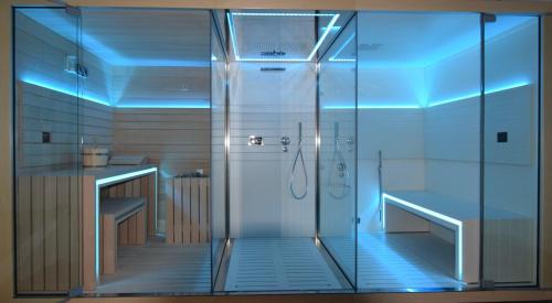 a bathroom with a shower with blue lights at Apartment with Panoramic Views, San Juan de Capistrano, Nerja in Nerja