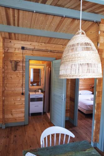 a room with a bedroom and a bed and a chandelier at Finca Florida in Benalup Casas Viejas