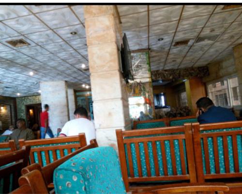 a group of people sitting in a restaurant at Salvatore Rooms With Breakfast -Train Station in Mansoura