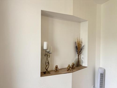 a wall with a shelf with a candle on it at • CosyHouse By Janna • Terrasse - Wifi in Châtellerault
