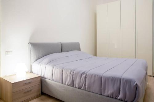 a bedroom with a bed and a nightstand with a purple blanket at Appartamento Adda10 in Milan