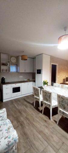 a kitchen with a table and chairs in a room at Borostyánkút Wellness Home Bakonybél in Bakonybél
