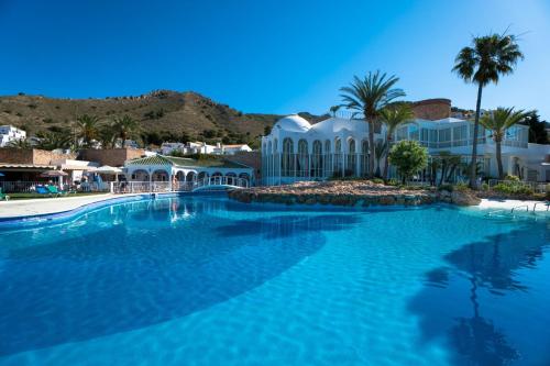 a large swimming pool in front of a resort at Apartment with Panoramic Views, San Juan de Capistrano, Nerja in Nerja