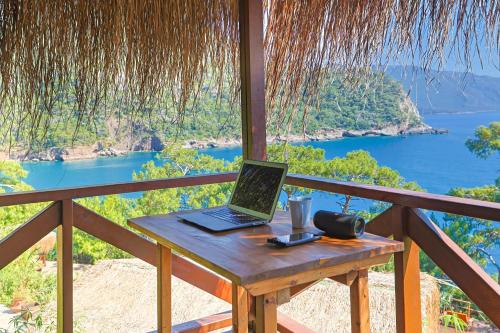 a laptop computer sitting on a table on a balcony at La Boheme Kabak Adults Only in Faralya