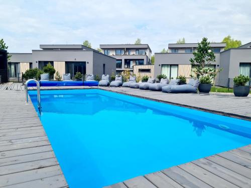 a swimming pool with blue water in front of a building at SeaFly in Palanga