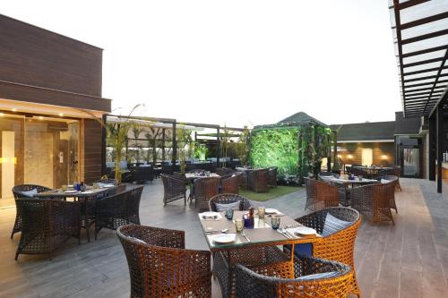 a restaurant with tables and chairs on a patio at Fortune Ranjit Vihar, Amritsar - Member ITC Hotels' Group in Amritsar