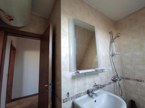 a bathroom with a sink and a mirror at Varna Seaview Apartment in Varna City