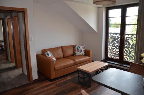 a living room with a couch and a table at FloraVilla in Rajecké Teplice