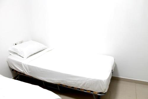 a bed in a room next to a white wall at Beach Suite Israel - Indoor Pool, Best View, Gym, Massage Chair, Spa ביץ סוייט ישראל - נוף ים מאלף, בריכה מקורה, כיסא מסאז, חדר כושר וספא in Ashqelon
