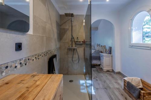 a bathroom with a shower and a wooden table at Villa les cigales in Le Thoronet