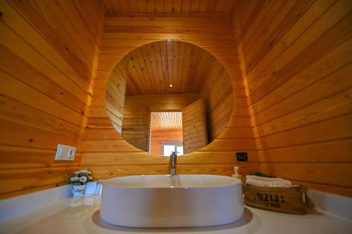 a bathroom with a round sink in a wooden wall at Le Parc des Oliviers in Marrakech
