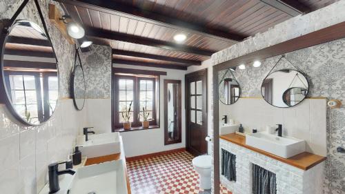 a bathroom with two sinks and two mirrors at Luxury Colonial Country Villa in Moya