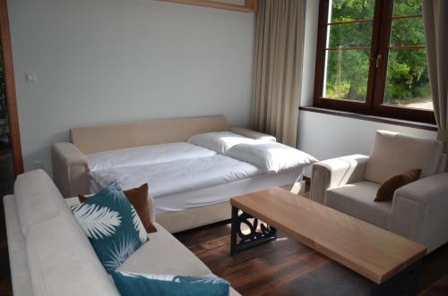 a living room with two couches and a coffee table at FloraVilla in Rajecké Teplice