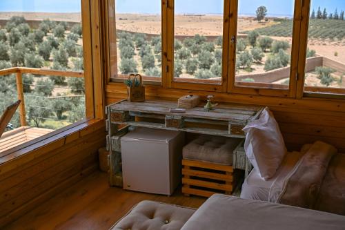 a room with a table and two windows with a view at Le Parc des Oliviers in Marrakech