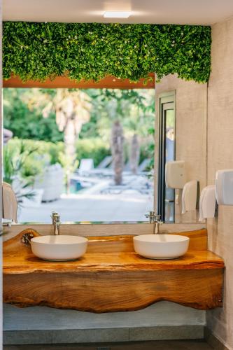 a bathroom with two sinks and a large mirror at Touch Hotel in Lozenets