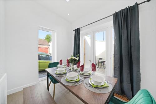 a dining room with a wooden table and chairs at Bristol Short Stays Brislington Sleeps 4-9 Free Parking in Bristol