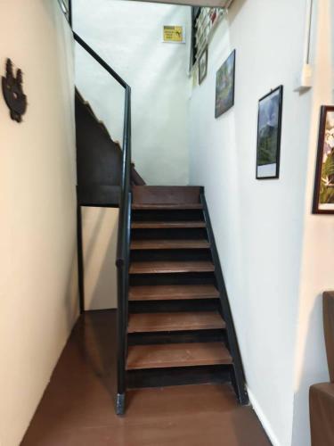 a staircase in a room with a stair case at De Cameron Guest House in Tanah Rata