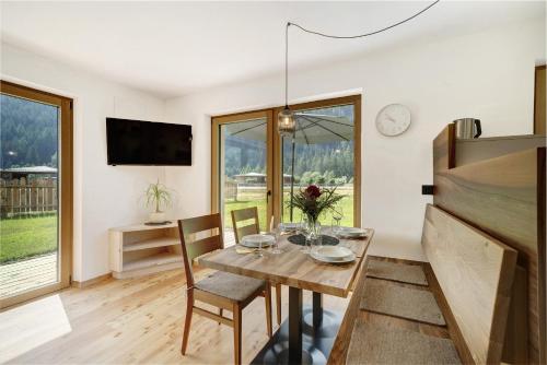 a kitchen and dining room with a table and chairs at Masi Rosmarin in Santa Valburga St. Walburg