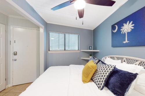 a bedroom with a white bed and a ceiling fan at Sea Side Villas 108 in Hilton Head Island