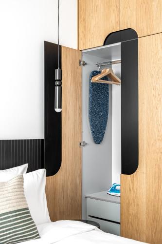 a bedroom with a bed and a wooden door at Mate GEORGE - By HOMY in Tel Aviv