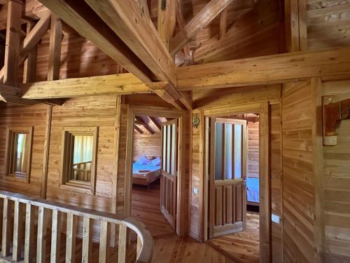 a log cabin with a wooden ceiling and a room at Sedir Palas in Cıralı