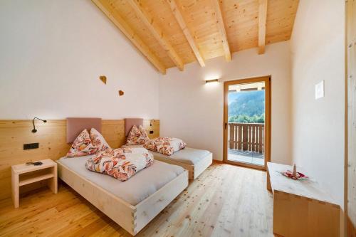 a bedroom with two beds and a balcony at Masi Lavendel in Santa Valpurga