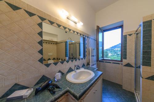 a bathroom with a sink and a mirror at La Rosa - Luxury B&B in Ischia