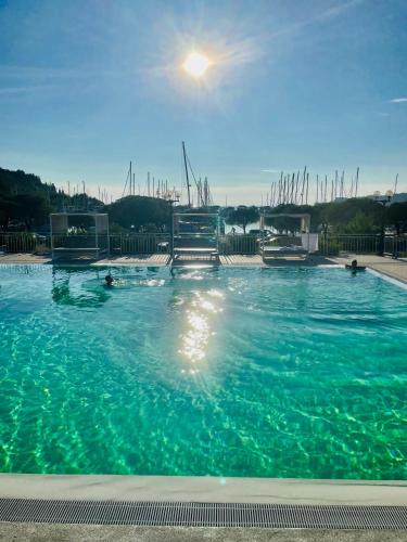 a large pool of blue water with people in it at Floating Sea house MIRAMARE in Portorož