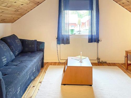 a living room with a blue couch and a table at 7 person holiday home in MOTALA-By Traum in Motala