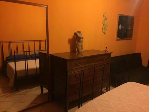 a bedroom with a dresser with a bear statue on it at Valerio's Home Historical Center in Larino