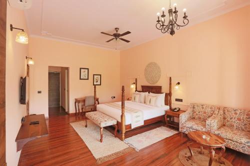 a large bedroom with a bed and a couch at Ratan Villas Sariska in Alwar