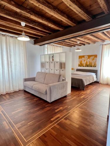 a living room with a couch and a bed at La Dolce Casa in Bergamo