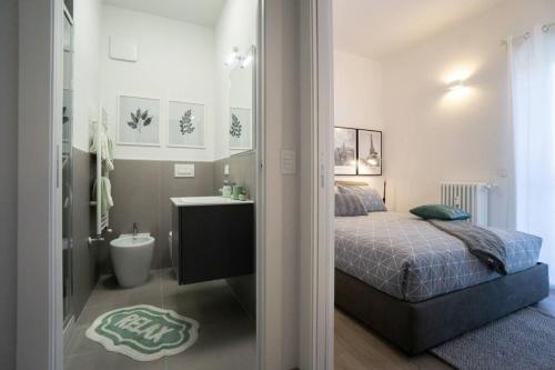 a small bedroom with a bed and a bathroom at 2 Bed Apartment Sleeps 4 - En-Suite Bath -Tv -WiFi in Asti