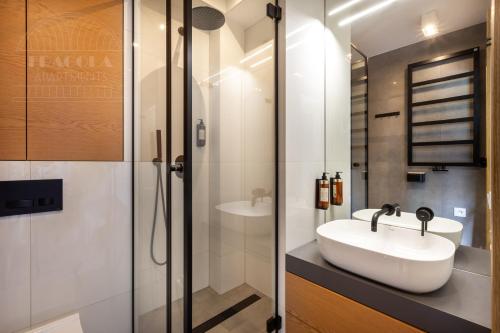 a bathroom with a sink and a shower at ArtSquare Fragola Apartments in Kraków