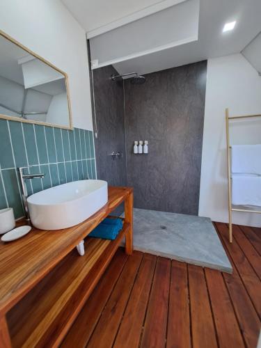 a bathroom with a tub on a wooden floor at PRANA hOMe in San Carlos