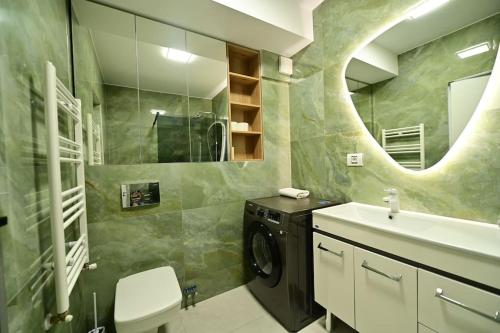 a bathroom with a washing machine and a sink at FLH - The Lake Home - Apt 33 in Sibiu